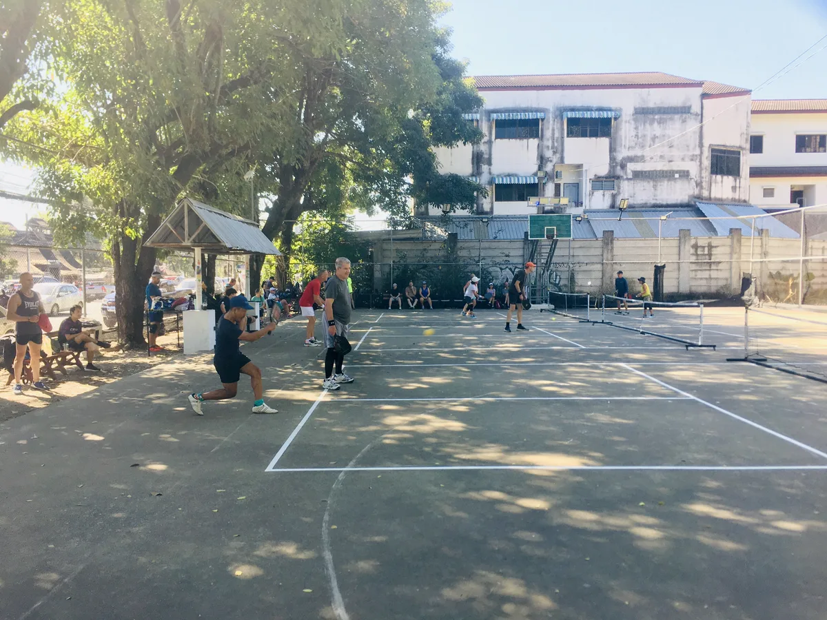Players rallying on a Chiang Mai pickleball court