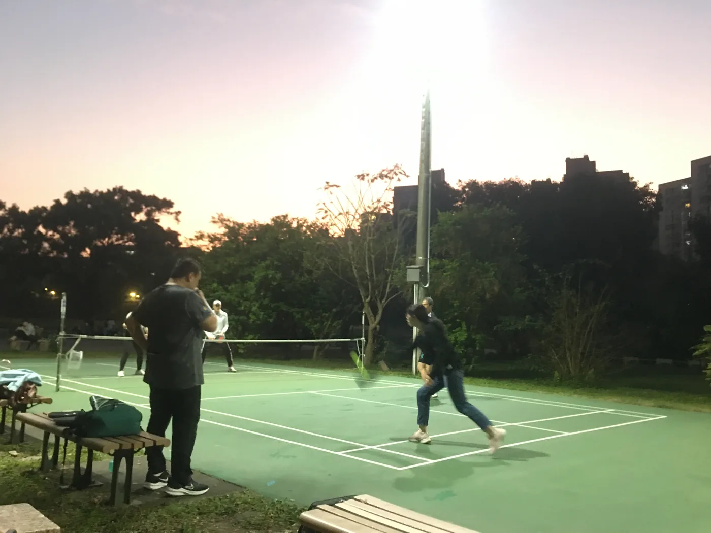 Evening pickleball session on an outdoor court in Taipei